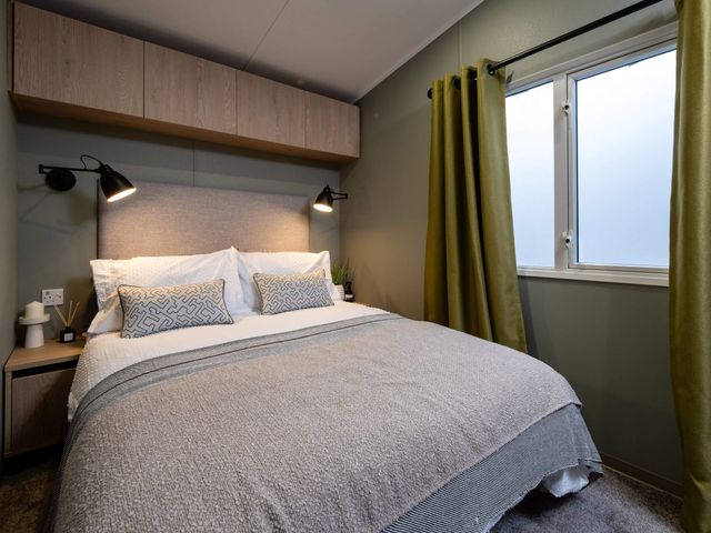 A bedroom with a bed and curtains at Arlington 40 x 14 Three Bed - 2 in Northwich