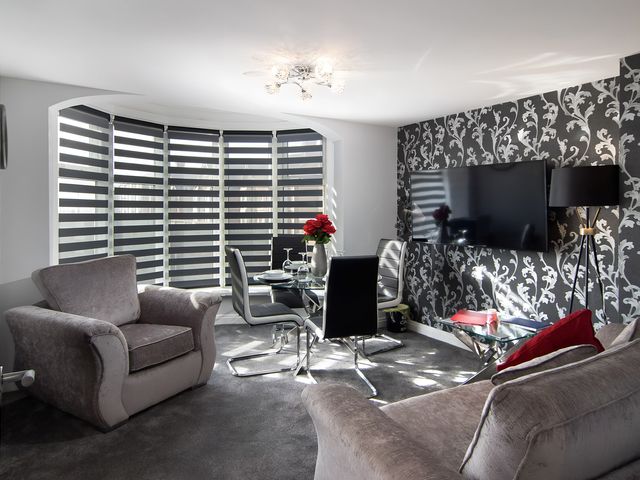 A living room with a sofa and television at Apartment 2 in Blackpool