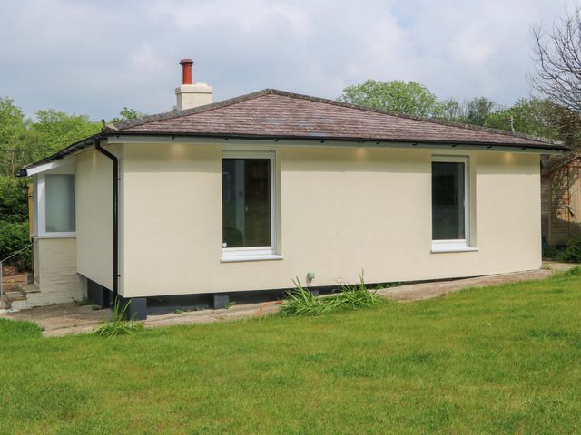 A house with grass in the foreground at Woodside in Battle