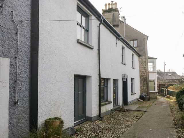 An exterior view of a residential building with windows and a path at No.2 The Flags, Grange-over-Sands