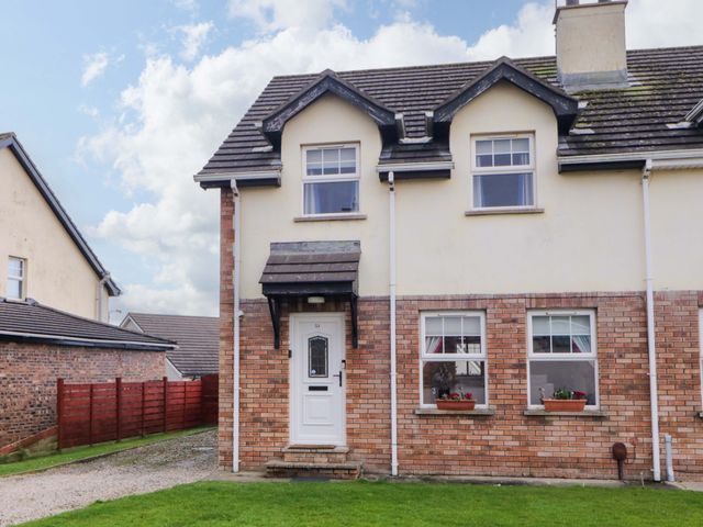 A front view of a house with a door and windows at Primrose Seaside Escape