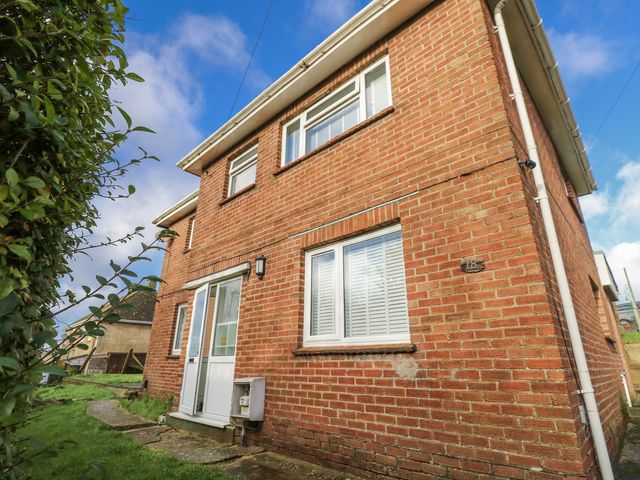 A brick house with a front door and windows at Red Brick Haven East Cowes, Isle Of Wight
