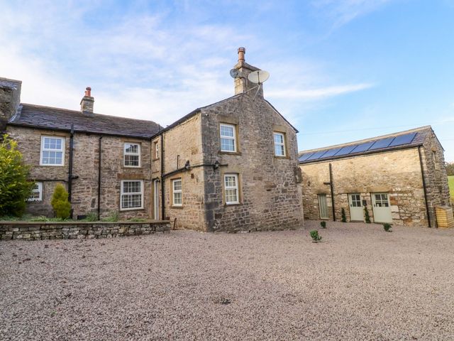 A stone house with satellite dish and gravel driveway at Cowside Farm in Langcliffe near Settle