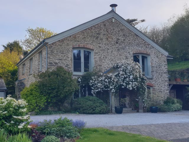 A stone house with plants in front at Kerslake House in Crafthole
