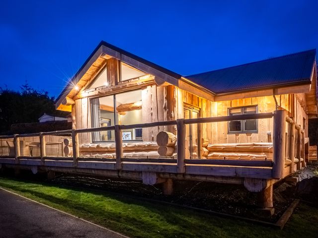 A wooden cabin with a deck and windows at Bears Den Addingham