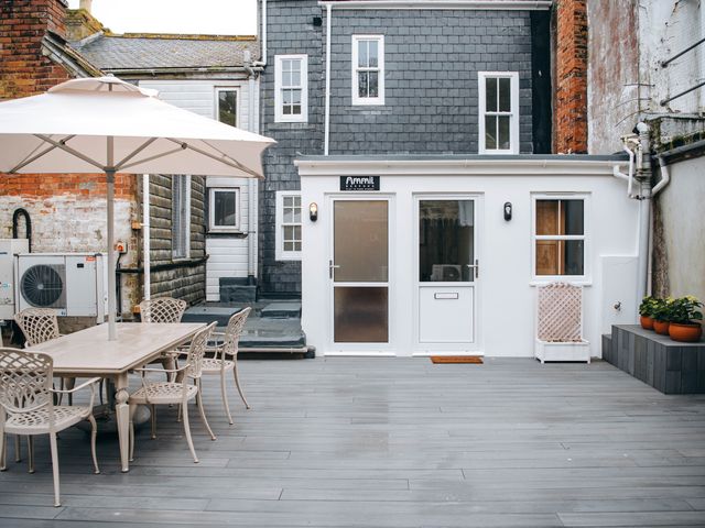 An outdoor area with a table and chairs at Ammil Bespoke