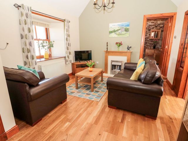 A living room with a sofa and coffee table at Cygnet Cottage Berwick-upon-Tweed