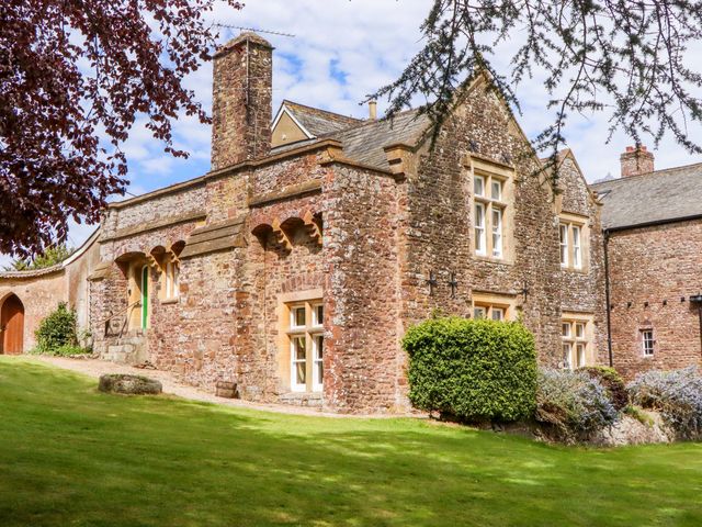 A stone building with windows and a door outside at Dowrich West Wing Apartment in Crediton