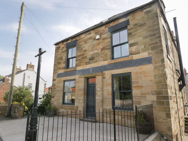 A stone house with windows and a door at Mulgrave House in Saltburn-by-the-Sea