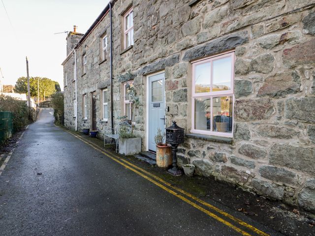 A stone exterior of a house with windows and door at Lon Popty Dolgellau