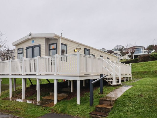 A mobile home with a deck and steps at Gorse Hill 211 Exmouth