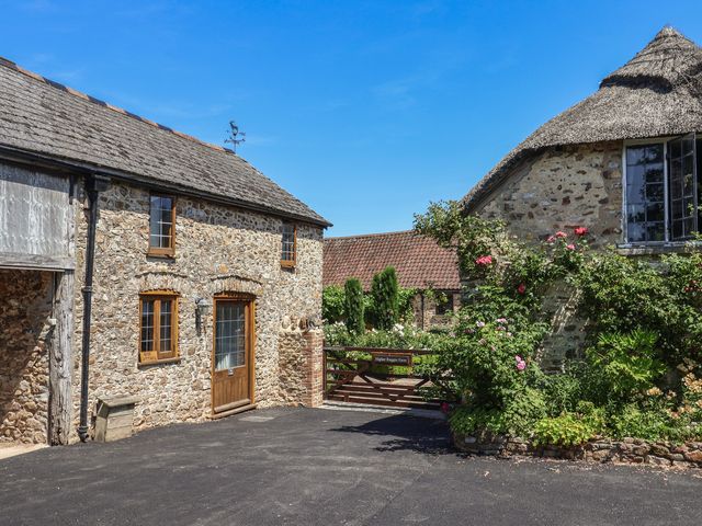 An outdoor area with stone buildings and a gate at Rose Cottage in Wellington