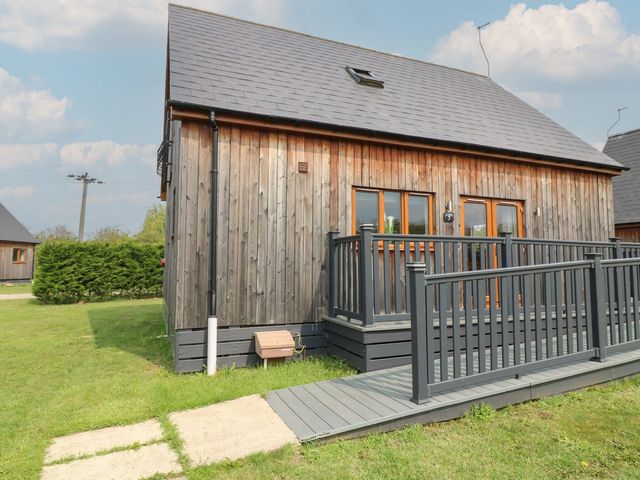 A wooden house with decking and garden area at James Ville Marina Lodge 7 in Brigg