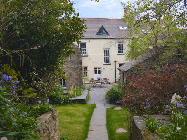 A garden with a house in the background at The Secret Garden in Narberth