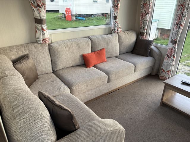 A living room with a sofa and coffee table at Harlyn Hideaway (Swift Barritz) Padstow