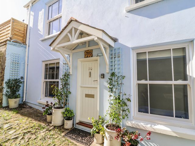 A front entrance with door and plants at Hideaway Cottage