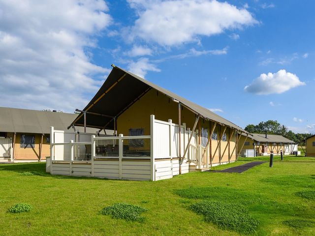 A tent structure with a deck in a grassy area at Kruger (Pet) Penrith