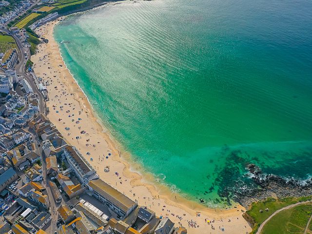 An aerial view of a beach with people and buildings at 28 Piazza in St Ives