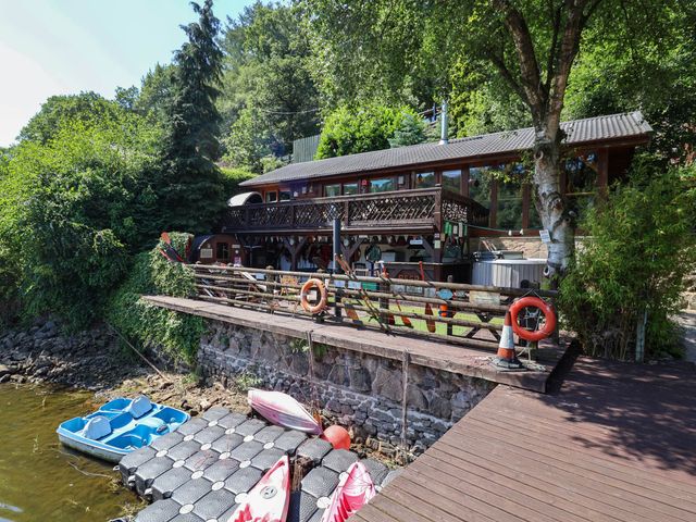 An outdoor area with a house and kayaks at The Boat House Rudyard Lake