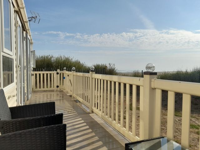 A deck area with chairs and table at Sands Retreat in Redcar