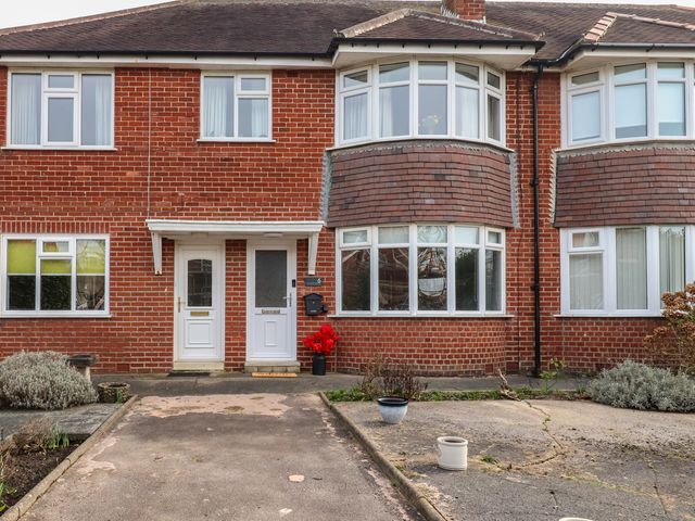 An outdoor view of a brick front facade with windows and doors at Seaside Serenity in Lytham St. Annes