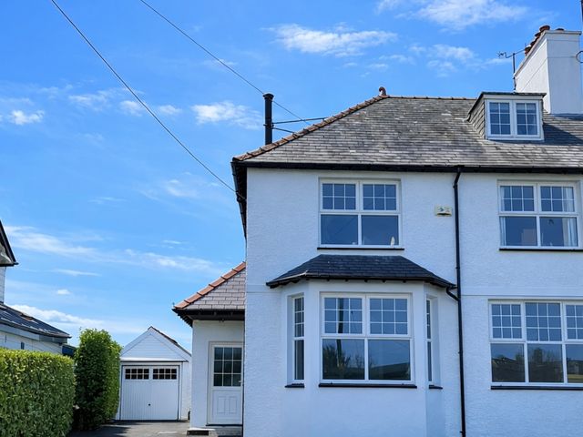 A house with a garage and windows at Bryniau in Morfa Nefyn