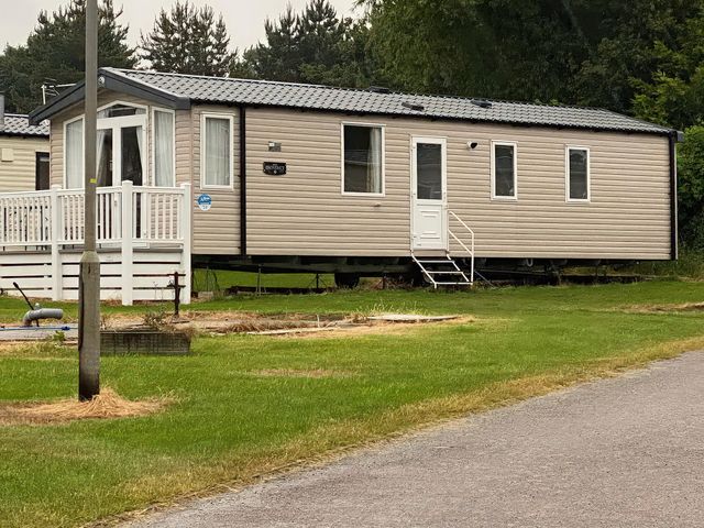 A static caravan with a deck and steps at Thameside Allhallows