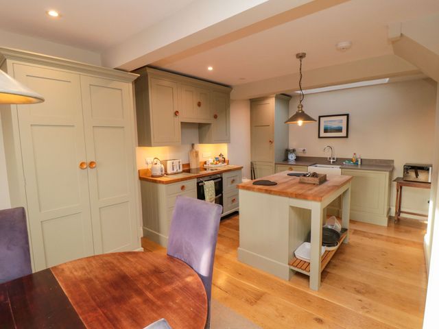A kitchen with an island and sink at St. Anthonys in York