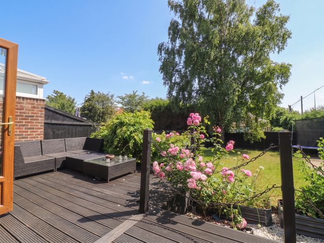 A garden with seating area and flowers at 57 Howden Avenue Doncaster