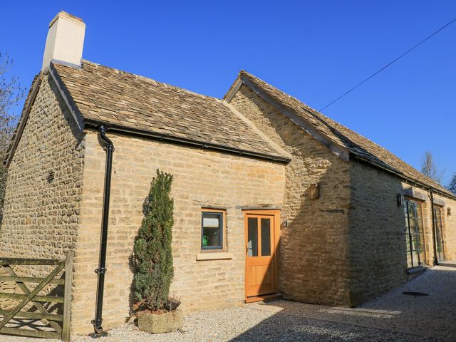 An outdoor view of a stone house with a gravel driveway at The Forge Broadway near Stow-On-The-Wold