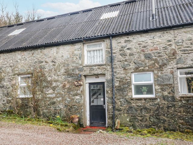 Exterior view of a stone cottage with a door and windows at Sycamore near Killean Farmhouse Cottages near Inveraray