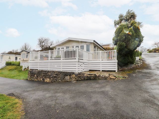 A house with a deck and landscaped area at Lodge 134 Lon Bryn Mair near Bellech