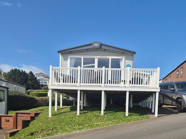 A house with a deck and car parked nearby at 21 Gorse Hill in Exmouth