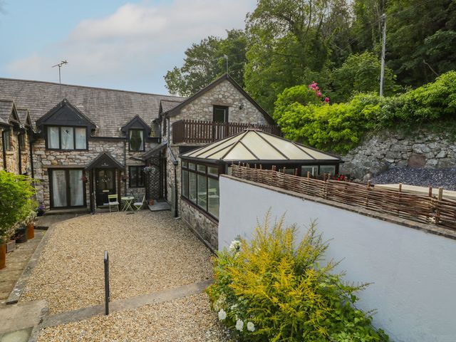 A house with a garden and gravel area at Ivy Cottage Abergele