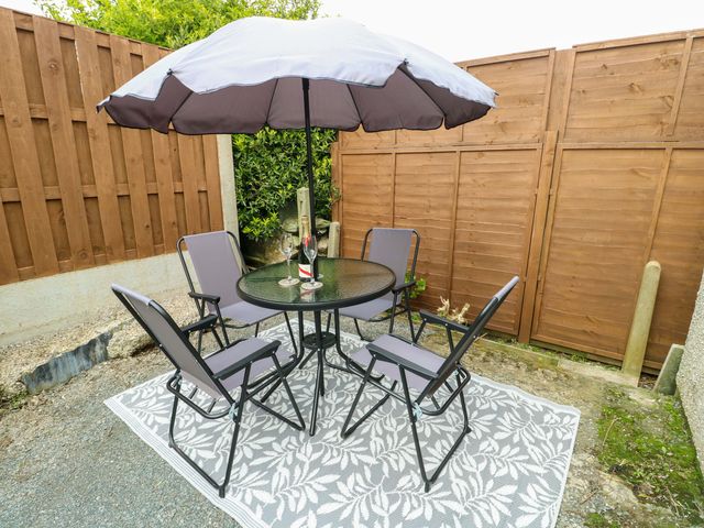 An outdoor seating area with a table and chairs at Min Y Cae 