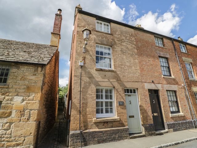 A two-story building with windows and doors at Tea Tree Cottage in Chipping Campden