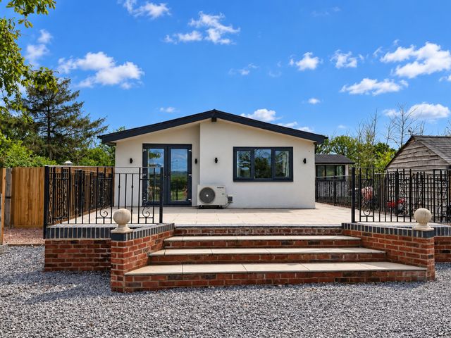 A house with patio and steps at Meadow View Cottage in Gloucester