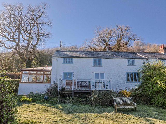 A house with a garden and deck area at 2 Oak Tree Cottages Marshwood Nr. Hawkchurch