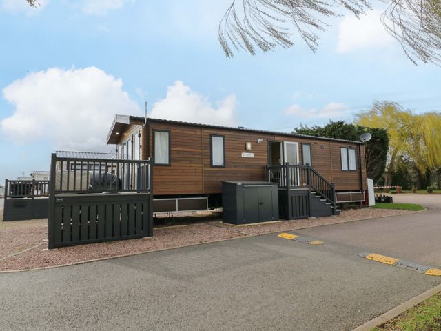 A mobile home with steps and porch at AV18 Tiddington