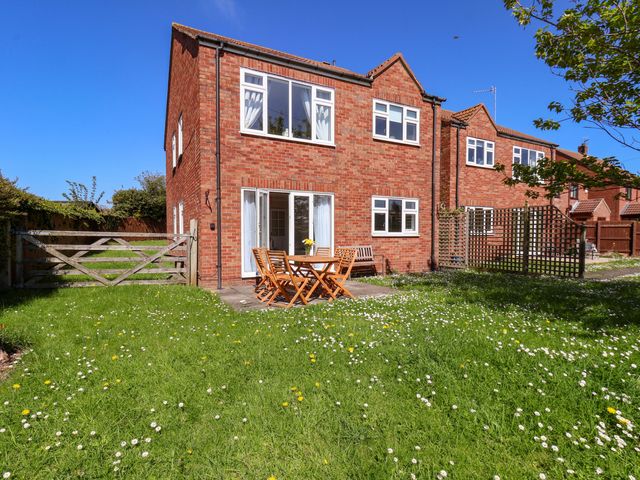 A garden with a table and chairs at Seashells at Runswick Lodge Runswick Bay