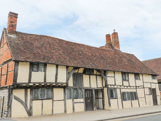 A traditional timber-framed building with a thatched roof at 4 Masons Court Stratford-upon-Avon