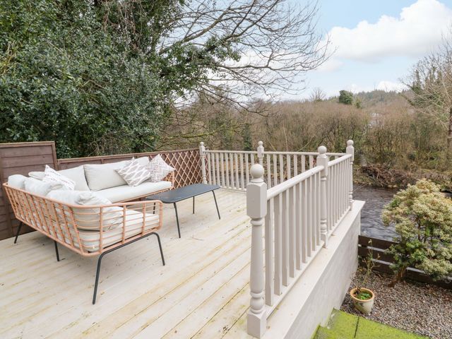 An outdoor seating area with a sofa and coffee table at 7 Brewery Pool in Newton Stewart