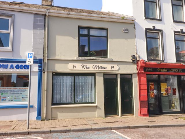 A building facade with signage at Macmathuna in Kilrush, County Clare