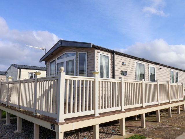 A caravan with a deck and railings at Caravan B14 Beechrise in Filey