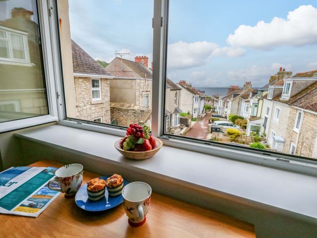 A kitchen with a view of a street and houses at Flat 3