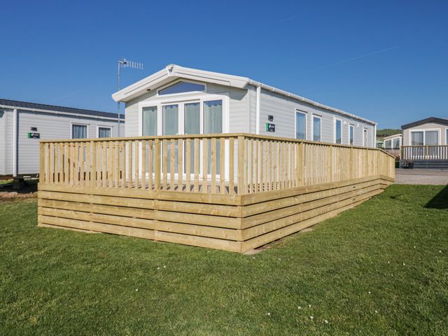 A mobile home with decking and grass area at Willerby High End Brand S6 (on Coniston) St Bees