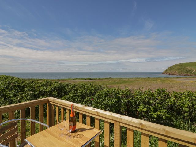 Outdoor area with a table and champagne overlooking the sea at The Swift in St Bees