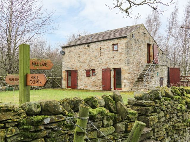 A stone building with stairs and signage at The Bothy in Leyburn