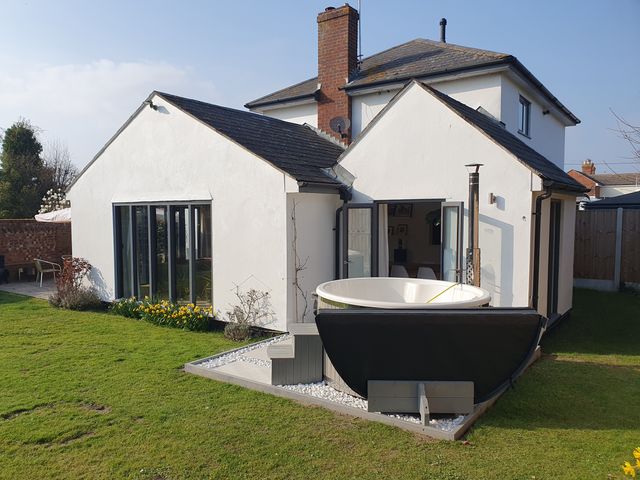 An outdoor view of a house with a bathtub in the garden at Island Retreat in Colchester