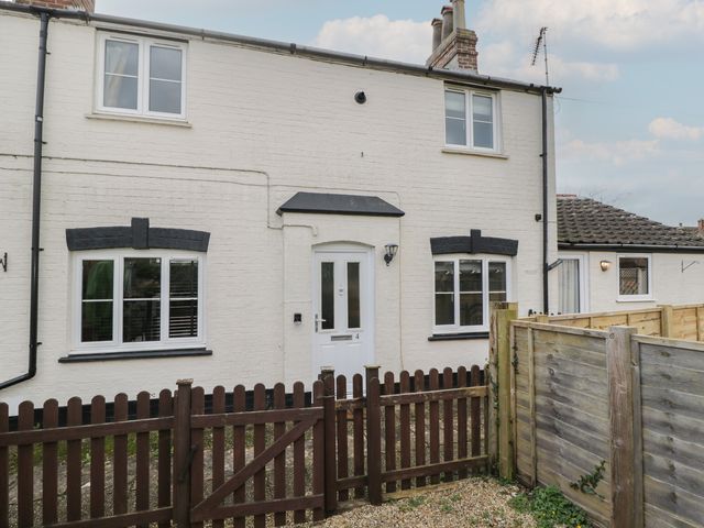 A house exterior with a fence and door at Copper Cottage in Devizes